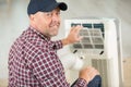 man fixing and maintaining air conditioning system Royalty Free Stock Photo