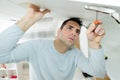 man fixing overhead door cupboard Royalty Free Stock Photo