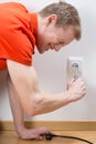 Man fixing socket being electrocuted