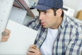 man fixing wood door cupboard Royalty Free Stock Photo