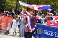 Man with a flag at the New Yorkers come out in large numbers to watch the Dominican Day Parade