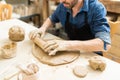 Man Flattening The Clay With Rolling Pin In Pottery Class