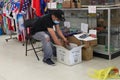 Man Flea Market Customer Wearing a Mask Looks through Boxes of Merchandise, Toy Cars Royalty Free Stock Photo