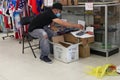 Man Flea Market Customer Wearing a Mask Looks through Boxes of Merchandise, Toy Cars