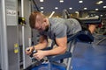 Man flexing leg muscles on gym machine Royalty Free Stock Photo