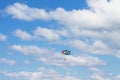 A man flies into the blue sky on a sports parachute. Royalty Free Stock Photo