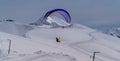 A man flies a hang glider in the Krasnaya Polyana ski resort, Sochi, Russia Royalty Free Stock Photo