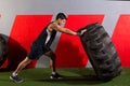 Man flipping a tractor tire workout gym exercise Royalty Free Stock Photo