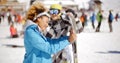 Man flirting with woman holding snowboard Royalty Free Stock Photo