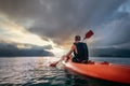 Man floating on kayak in the morning under sunrise sky on Cheow Lan Lake, Khao Sok national park, Thailand Royalty Free Stock Photo