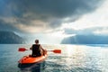 Man floating on kayak under sunrise sky on Cheow Lan Lake, Khao Sok national park, Thailand Royalty Free Stock Photo