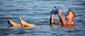 A man floating in the salty water of the dead sea. Royalty Free Stock Photo