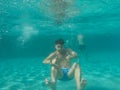 A Man floating under water in the pool Royalty Free Stock Photo