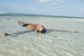 Man floating in water on the beach Royalty Free Stock Photo