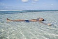 Man floating in water on the beach Royalty Free Stock Photo