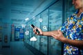 A man in a floral shirt holds a mobile phone forwarded in a manner that reads a message on the screen. There is a communication Royalty Free Stock Photo