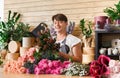 Man florist assistant in flower shop delivery make rose bouquet