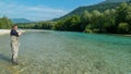 A man fly fishing on the alpine Soca River near Tolmin, Slovenia Royalty Free Stock Photo