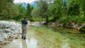 A man fly fishing on the alpine Soca River near Tolmin, Slovenia Royalty Free Stock Photo