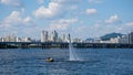 A man on a flyboard flies over a river against the backdrop of a beautiful view of Seoul