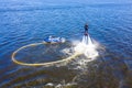 Man on the flyboard. Flyboard view from drone. Aerial view of water extreme action sport. Guy is flying at aquatic flyboard