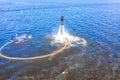 Man on flyboard. Flyboard view from drone. Aerial view of water extreme action sport. Guy is flying at aquatic flyboard