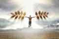 Man flying away with a leafs. Surreal autumn concept. Free man with wings made of leaves fly in the sky