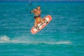 A man flying with kiteboard above the sea