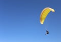 Man flying on a paraglider on the blue sky background