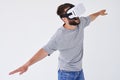 Man flying with stretched hands as he is using VR glasses Royalty Free Stock Photo