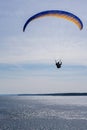 Man flying yellow and blue parasail
