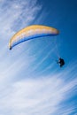 Man flying yellow and blue parasail