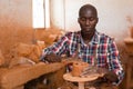 Man focused on work on pottery wheel