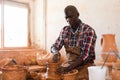 Man focused on work on pottery wheel