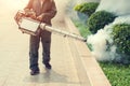 The man fogging to eliminate mosquito for prevent spread dengue fever Royalty Free Stock Photo