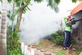 Man Fogging to prevent spread of dengue fever in thailand Royalty Free Stock Photo