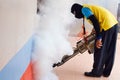 Man Fogging to prevent spread of dengue fever in thailand Royalty Free Stock Photo