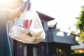 Man food dalivery wearing the protective gloves Deliver to home. woman receiving bags from postman . Postman giving. Royalty Free Stock Photo