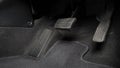 Man foot and accelerator and brake pedal inside the car Royalty Free Stock Photo