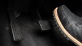 Man foot and accelerator and brake pedal inside the car Royalty Free Stock Photo