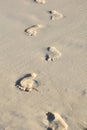 Man foot print on a white sand beach