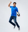 Man or football fan with soccer ball jumping