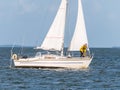 Man on foredeck of sailboat sailing on IJsselmeer lake, Netherlands Royalty Free Stock Photo