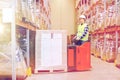 Man on forklift loading boxes at warehouse