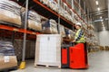 Man on forklift loading cargo at warehouse