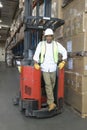 Man With Forklift Truck In Warehouse Royalty Free Stock Photo