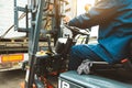 A man on a forklift works in a large warehouse, unloads bags of raw materials