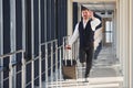 Man in formal clothes and with baggage is running forward and busy for a plane Royalty Free Stock Photo