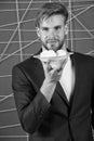 Man formal elegant suit hold plate with sweet marshmallow dessert. Bachelor elegant guy offer sweet treats. Hospitality