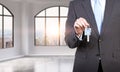 A man in formal suit holds a key in a modern loft panoramic apartment or office. Rent or buy new home or office. New York view. A Royalty Free Stock Photo